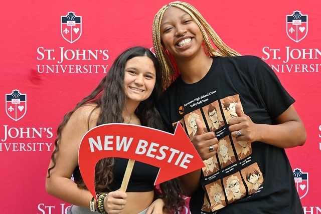 Students pose in front of St. John's step and repeat