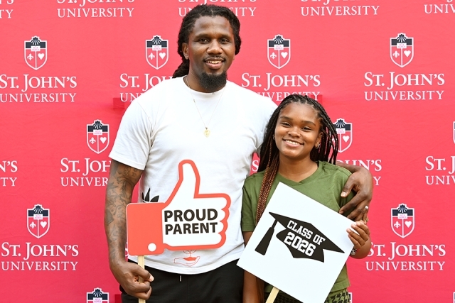Students in front of St. John's step and repeat