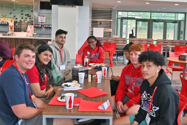 Students sitting at a table at orientation