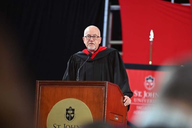 Rev. Rooney standing at podium