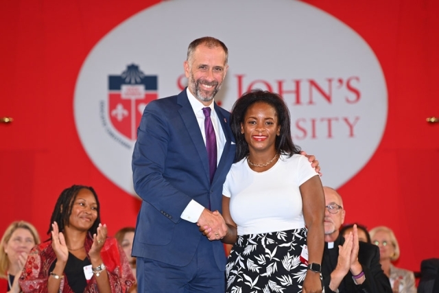 University community members pose for a photo onstage