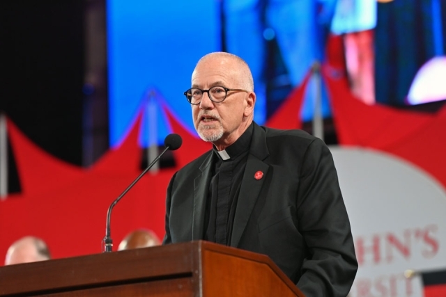 Rev. Rooney at the podium