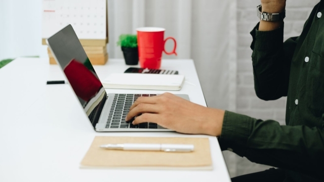 Someone using laptop at desk