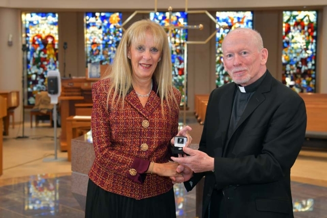 Fr Shanley handing award to female