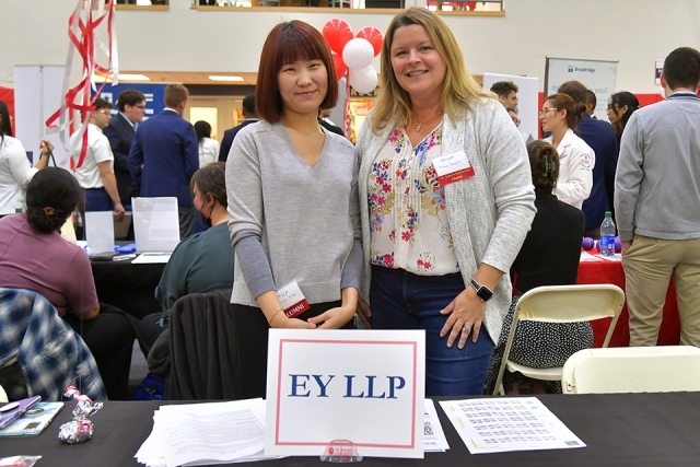 Two female recruiters posing for photo at career expo