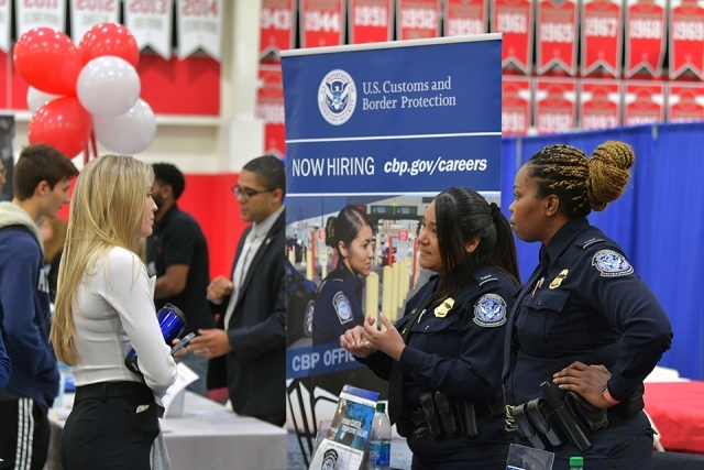 Students and law enforcement recruiters speaking at career expo