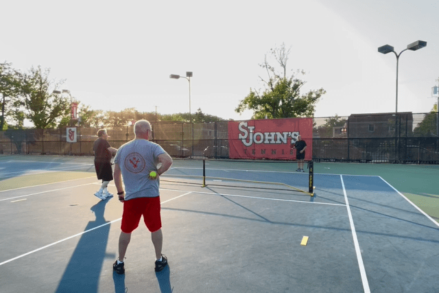 Alumni on the pickleball court outside