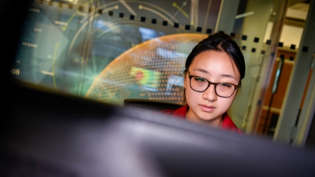 Female student looking at computer monitor