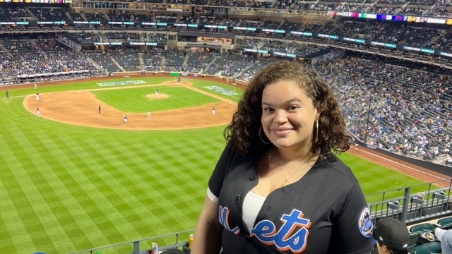 St. John's Law student Samantha Velez wearing a New York Mets jersey in the stands at Citi Field.