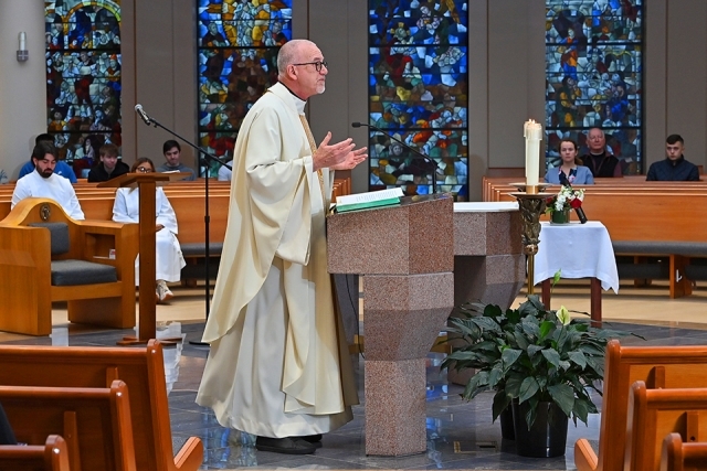 Fr. Rooney speaking during Mass