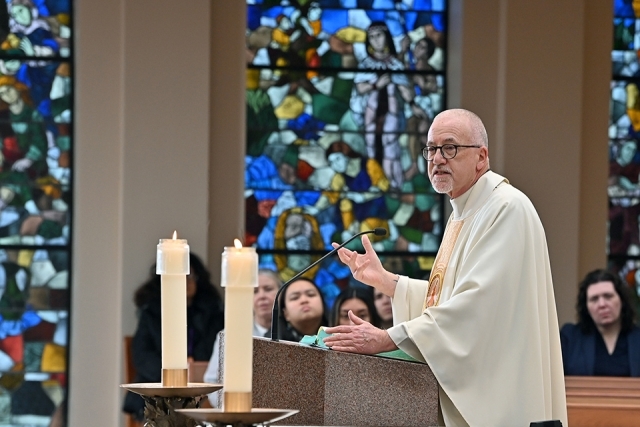 Fr. Rooney speaking during Mass