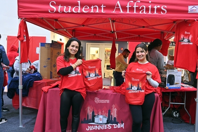 Student Affairs booth displaying Johnnies Day shirts and promo materials