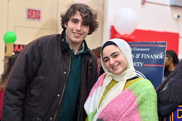 Two students pose for a photo