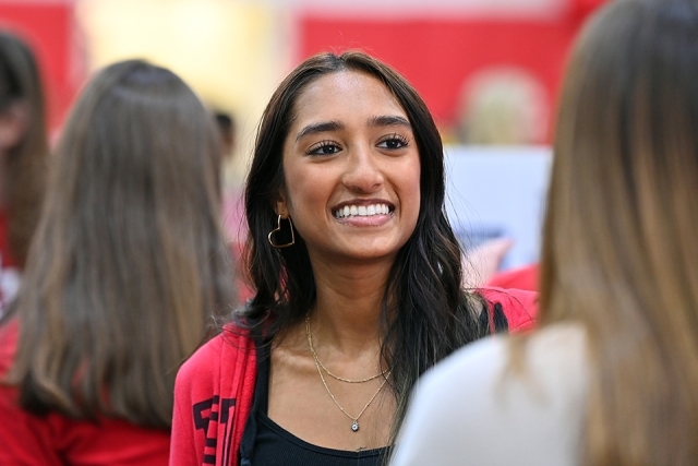 Student at Student Activities Fair smiling