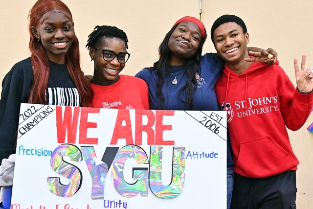 SYGU members pose for a photo with poster
