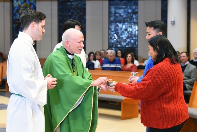 Fr Shanley handing out blessing to couple