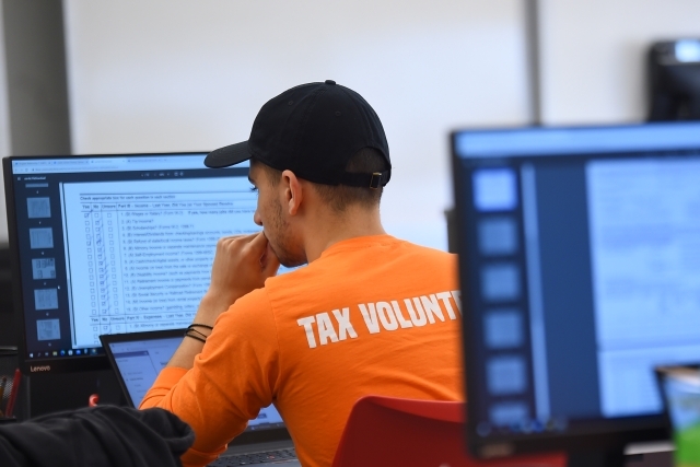 Student Tax Volunteer working on tax returns on desktop