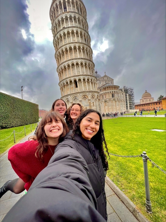4 females taking a selfie photo near the leaning tower of Pisa in Italy 