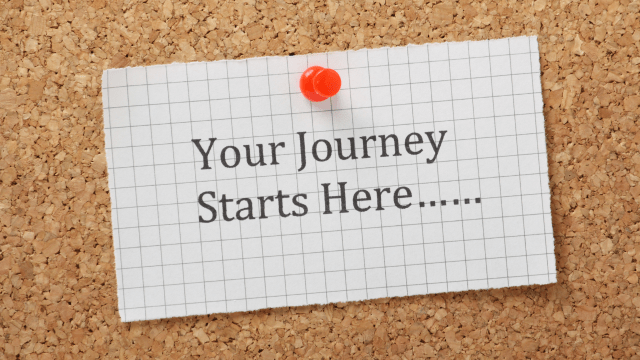 A paper pinned to a corkboard, with the words "your journey starts here"
