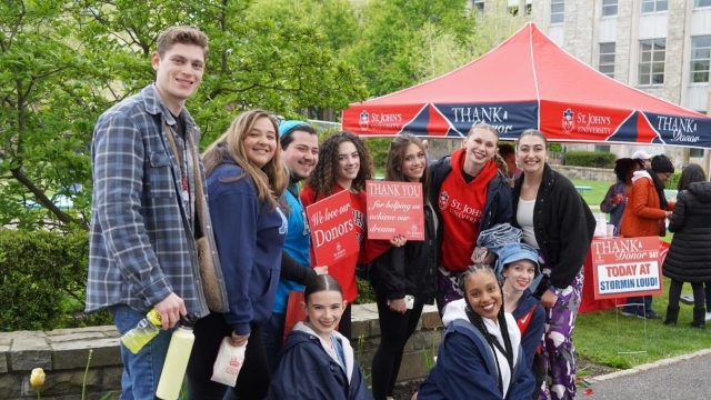 Students gathered for photo infront of Thank a Donor tent at St. John's