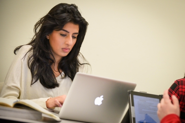 Female student working on her macbook 