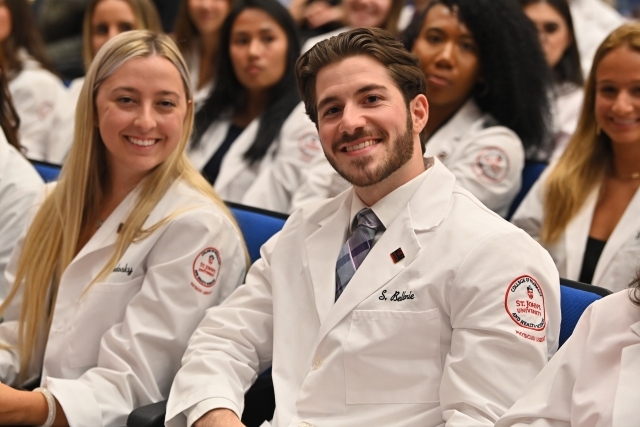 Physician Assistant students smile for a photo at the White Coat Ceremony