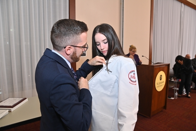 Student receiving their white coat