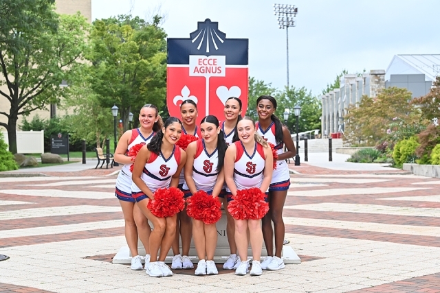 Cheerleaders pose for a photo