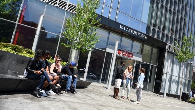 Group of actuarial science students talking in front of St. John's University Manhattan Campus
