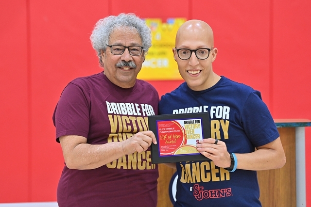 Two males holding award at Dribble for Victory over Cancer event 