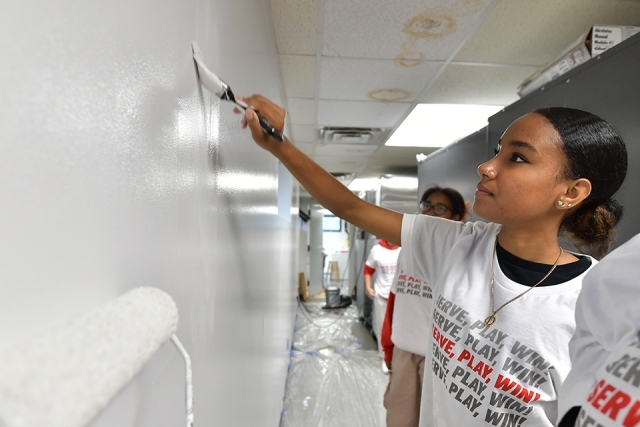 Students help paint walls for St. John's University Service Day 
