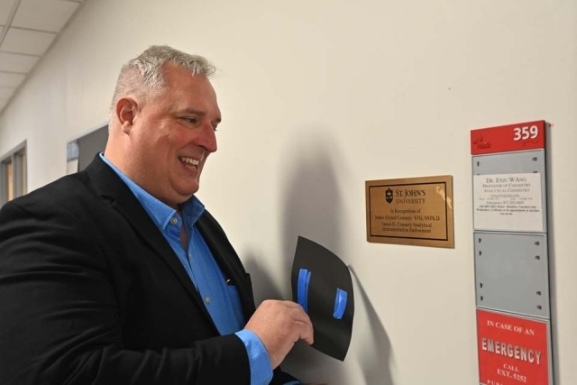St. John's employee unveiling James G. Connery plaque
