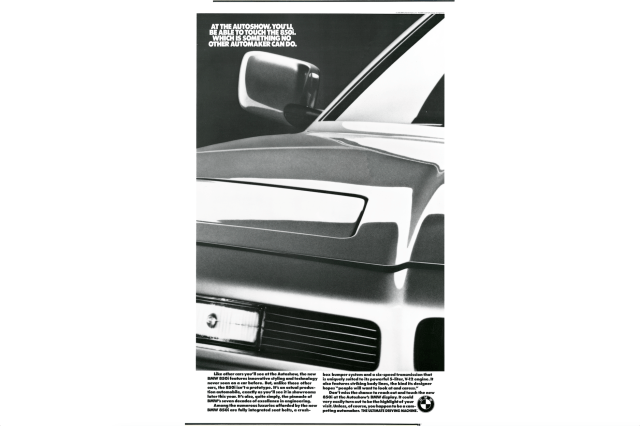 Text: At the Autoshow you'll be able to touch the 850i which is somethign no other automaker can do.  BMW ad featuring hood of car. 