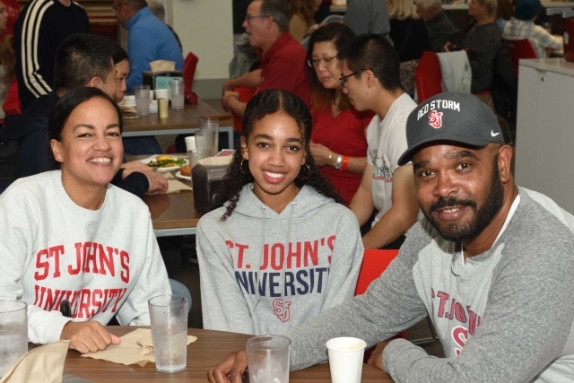 St. John's Student with parents enjoying a meal together
