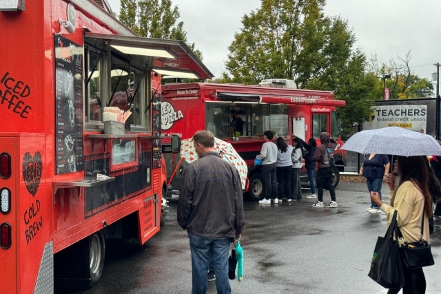 Visitors at food truck in the rain