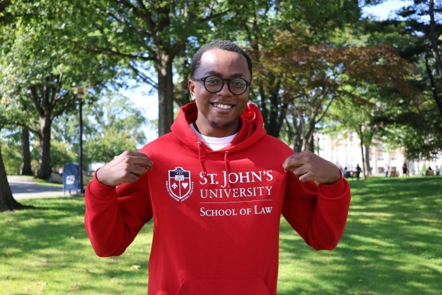 St. John's Law student holding up sweatshirt.