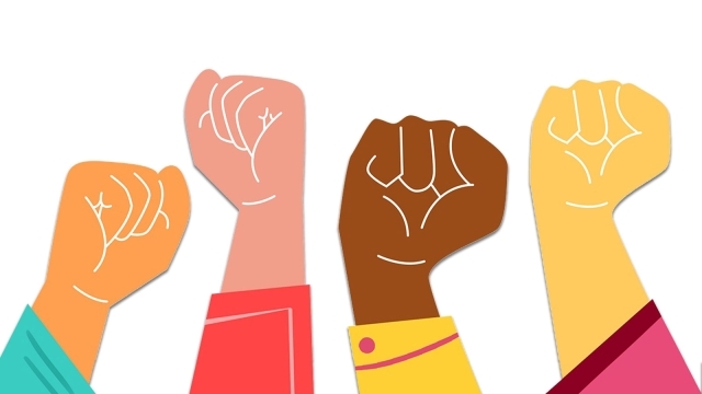 Illustration of four raised fists in different skin tones.
