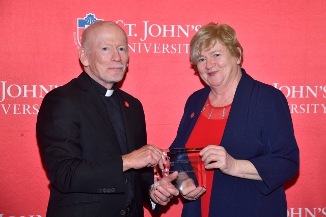 Fr. Shanley handing award to 2024 Training and Development Certificate Graduate