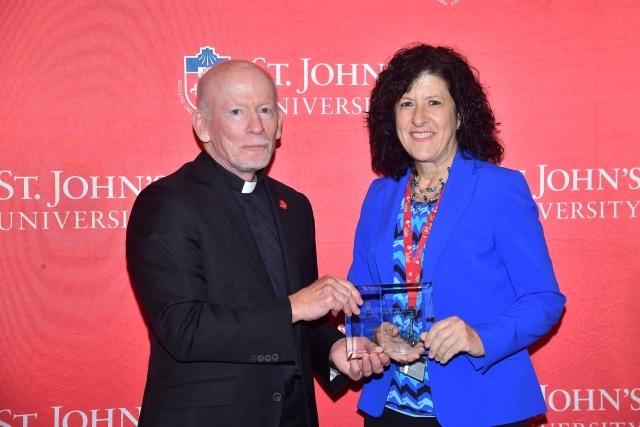 Fr. Shanley handing award to 2024 Training and Development Certificate Graduate