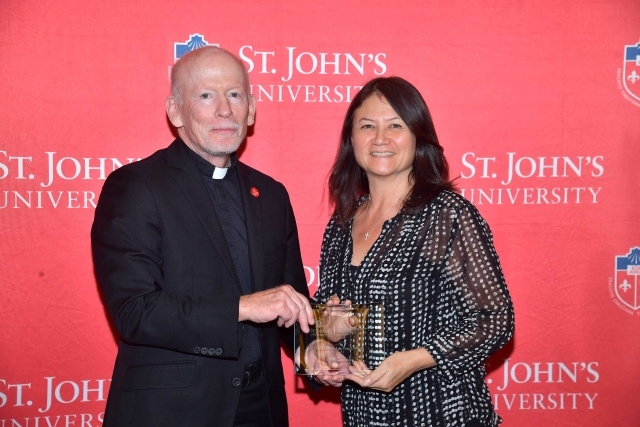 Fr. Shanley handing award to 2024 Training and Development Certificate Graduate
