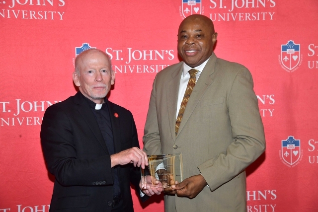 Fr. Shanley handing award to 2024 Training and Development Certificate Graduate