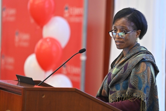 Female speaking at the podium at the 2024 Training and Development Certificate Graduation