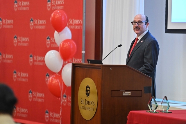 Male speaking at podium at the 2024 Training and Development Certificate Graduation