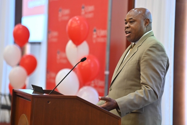 Steve Thom speaking at the podium at the 2024 Training and Development Certificate Graduation