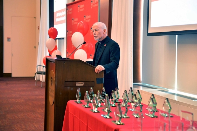 Fr. Shanley speaking at the podium at the 2024 Training and Development Certificate Graduation