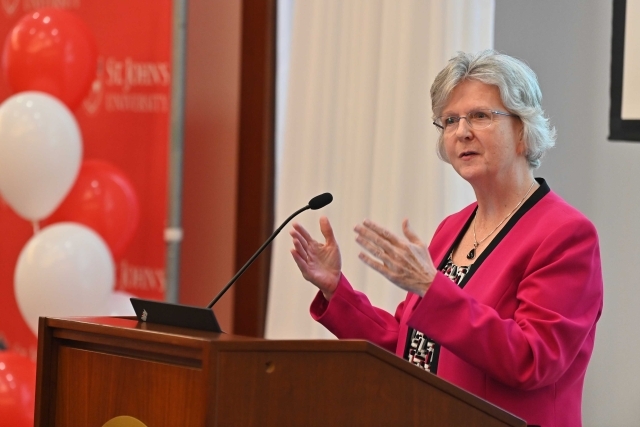 Eileen speaking at the podium at the 2024 Training and Development Certificate Graduation
