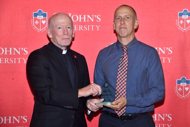 Fr. Shanley handing award to 2024 Training and Development Certificate Graduate