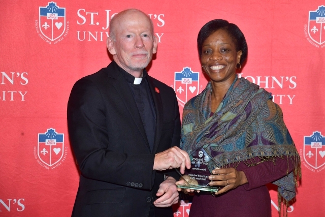 Fr. Shanley handing award to 2024 Training and Development Certificate Graduate