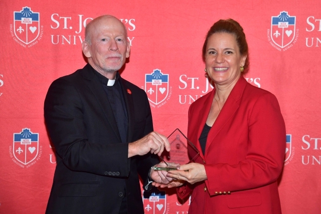 Fr. Shanley handing award to 2024 Training and Development Certificate Graduate