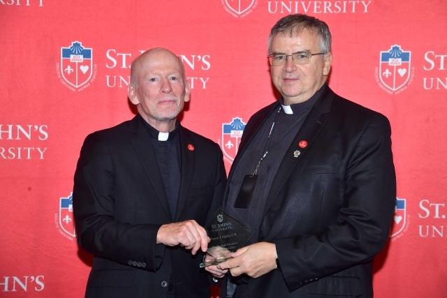 Fr. Shanley handing award to 2024 Training and Development Certificate Graduate